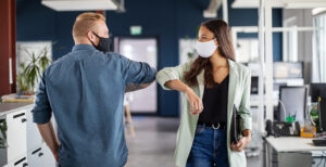 A man and a woman touching elbows in an office instead of shaking hands in an office. Just as it is important not to transfer germs, PM2.5 is just as important to control in office spaces. Ah, the corporate office building! Alas, many of your employees haven’t basked in its fluorescent glory for nearly two years. Soon, however, everyone will happily huddle once more in that near- windowless, monochromatic hive. After all, the air conditioning needs to blow the stagnant, freezing air of a thousand recycled sneezes down the back of somebody’s neck, or what’s an