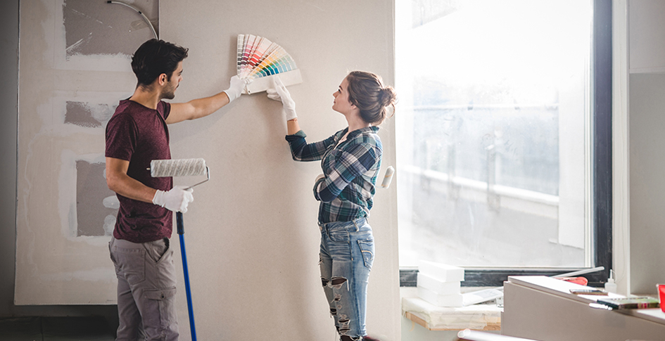 VOCs are in the office and the home; one prime example is paint. The picture shows a woman and a man choosing colors before painting.