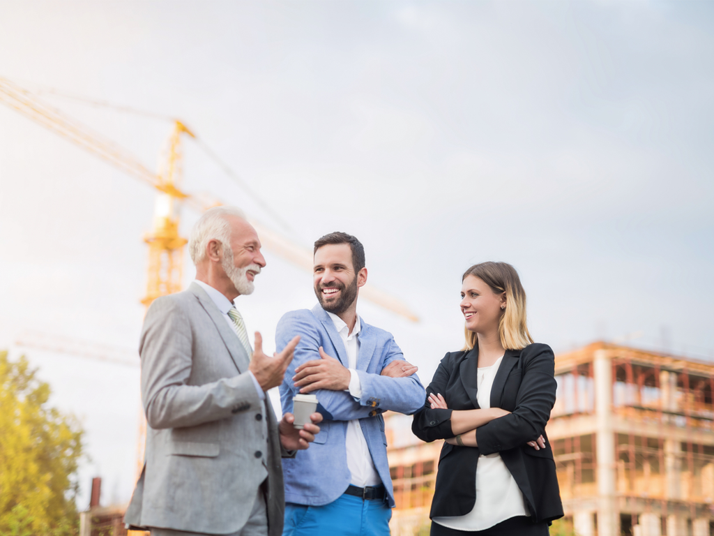 A group of people standing outside discussing ASHRAE 241 standards.