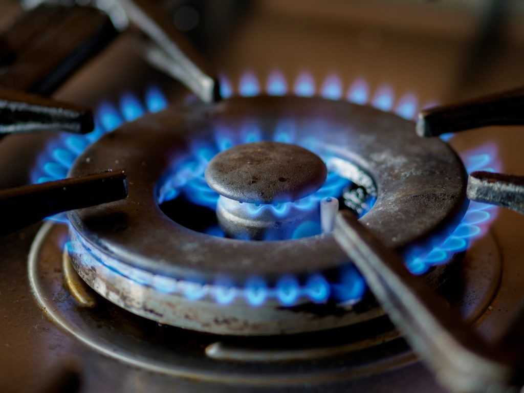 Blue flame from a gas burner on a stove, they produce volatile organic compounds in an enclosed space.