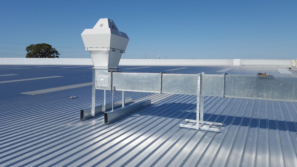 Steel roof of building with ductinge and a vent.