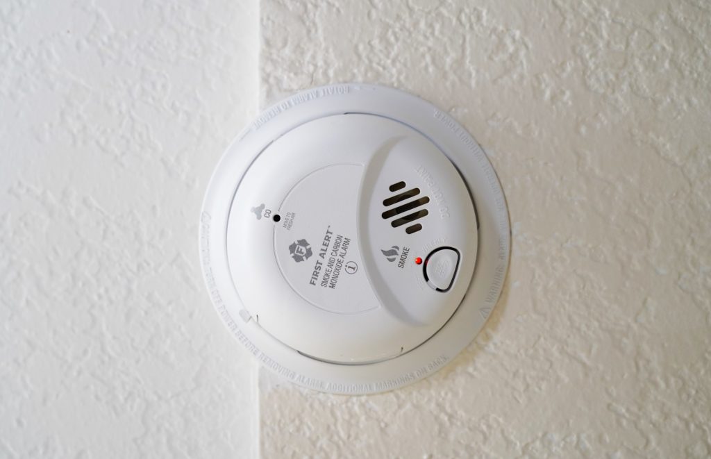 Fire and Carbon monoxide detector on wall, used to detect poor indoor air quality from gasses.